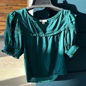 Deep green blouse, not cropped but not long